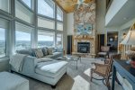Living Room with floor to ceiling windows that look over the pond and the valley below 